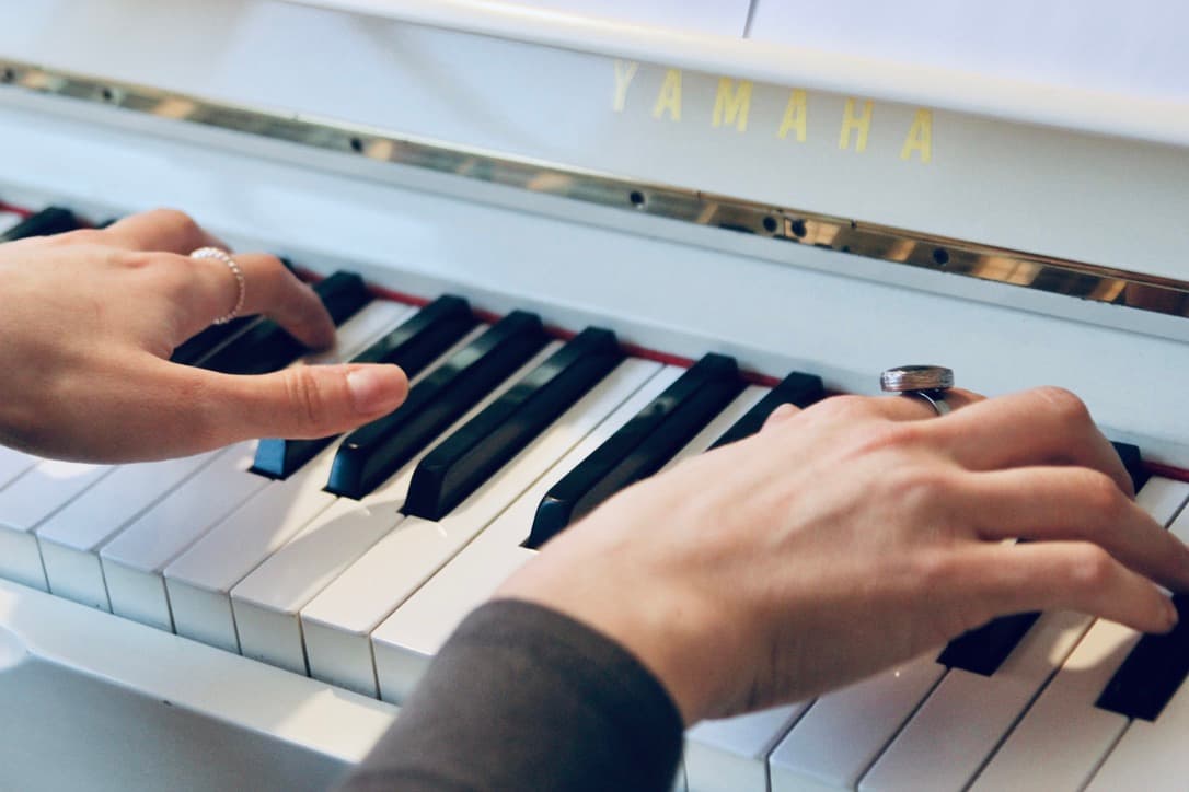 Hands on the piano keys during a lesson