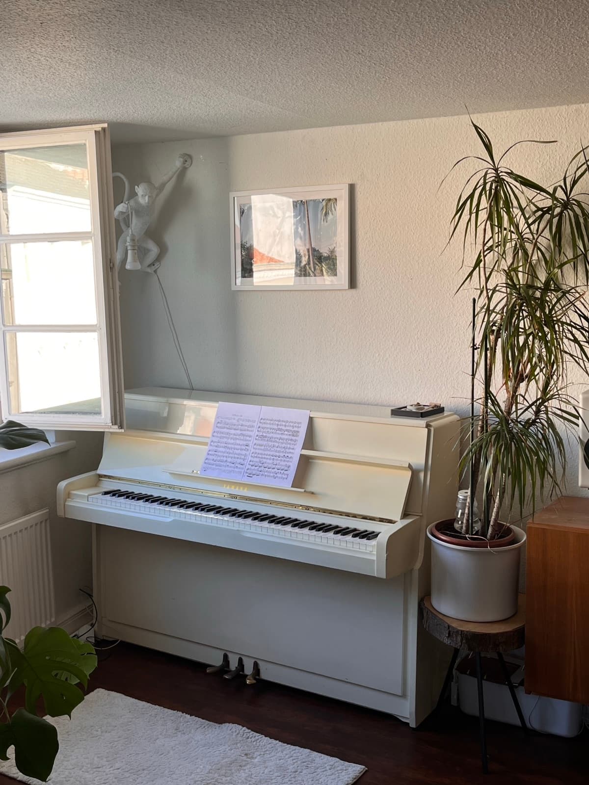 Upright piano in natural light by the studio window