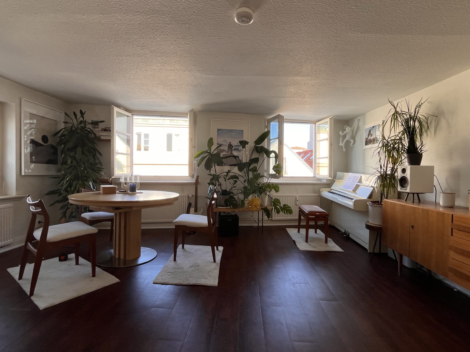 Wide view of the music studio in Hamburg — piano, table, and natural light